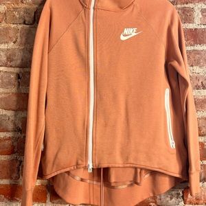 Peach Nike hoodie.